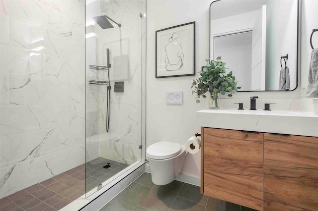 full bathroom with a marble finish shower, tile patterned flooring, vanity, and toilet