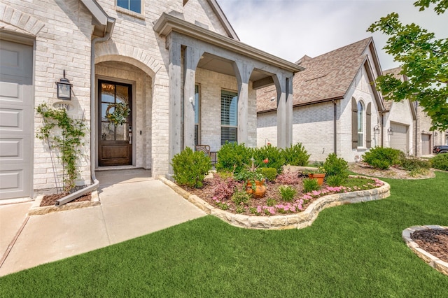 1130 Holcombe Dr, Anna, TX 75409 - view of exterior entry featuring a lawn, brick siding, and a porch