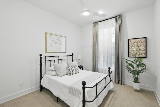 bedroom featuring a ceiling fan, baseboards, and light colored carpet
