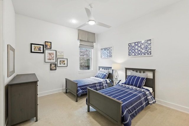 bedroom featuring baseboards, a ceiling fan, and light colored carpet