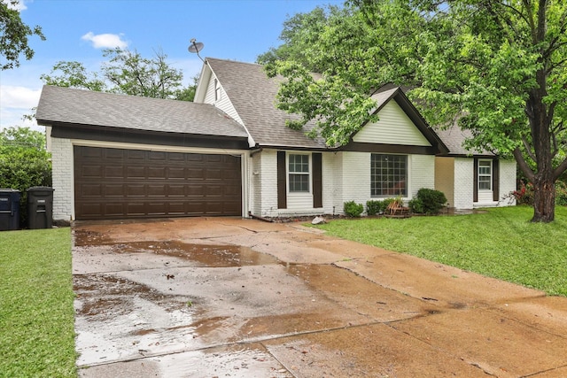 view of front of property with concrete driveway, brick siding, an attached garage, and a front yard
