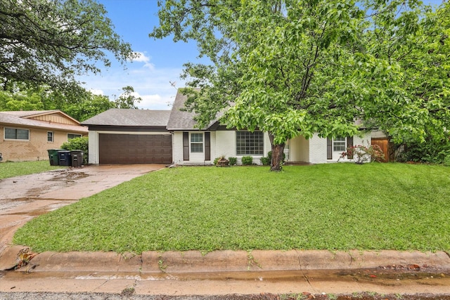 view of front of property featuring a garage, a front yard, roof with shingles, brick siding, and concrete driveway
