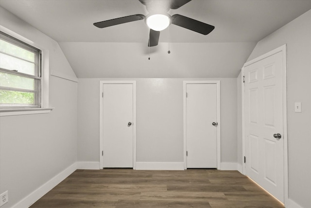 additional living space with baseboards, ceiling fan, vaulted ceiling, and wood finished floors