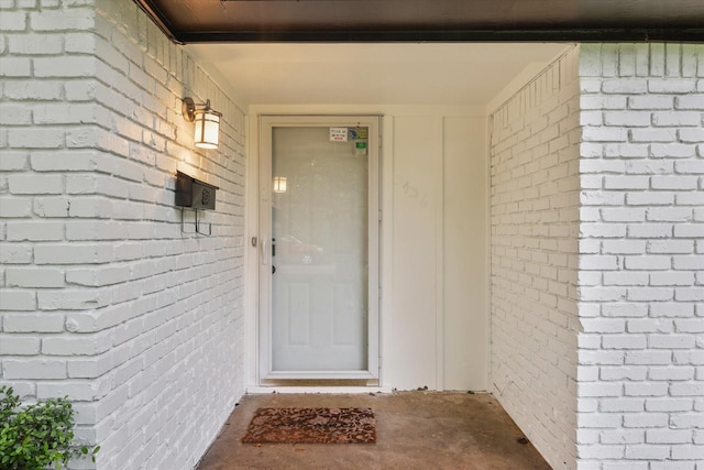 property entrance with brick siding