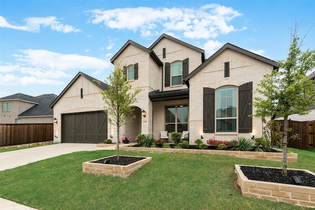 1719 Godello Dr, Mclendon Chisholm, TX 75032 - view of front facade with concrete driveway, brick siding, fence, and a front lawn