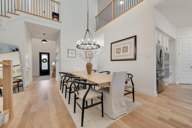 1719 Godello Dr, Mclendon Chisholm, TX 75032 - dining space with baseboards, light wood finished floors, a high ceiling, and a chandelier