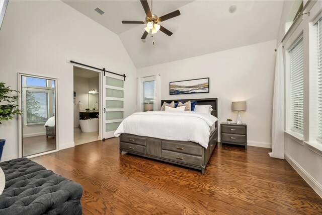 2203 Miranda Ln, Rockwall, TX 75087 - bedroom with a barn door, multiple windows, dark wood-style flooring, baseboards, and high vaulted ceiling
