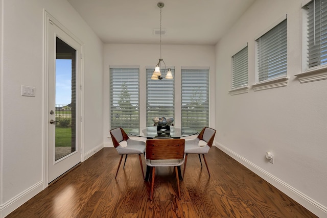 dining area featuring baseboards, visible vents, and dark wood-type flooring