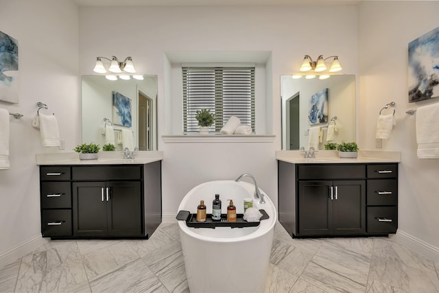 bathroom featuring a freestanding tub, baseboards, two vanities, and marble finish floor