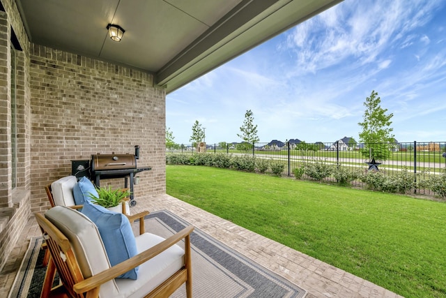 view of patio with grilling area and fence