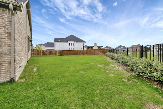 view of yard with a residential view and a fenced backyard