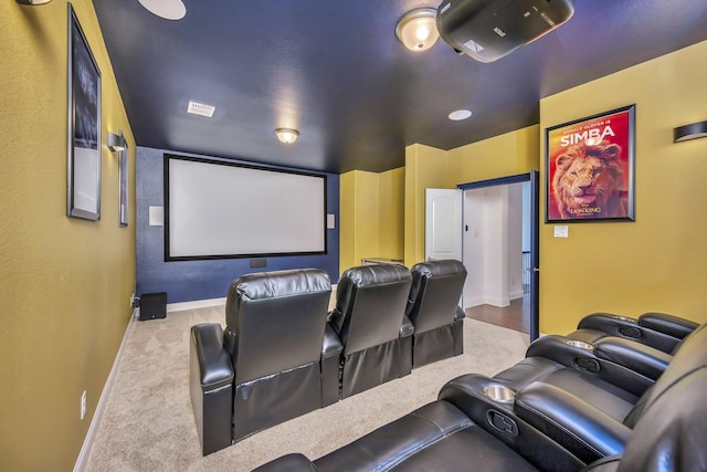 home theater room with carpet floors and baseboards
