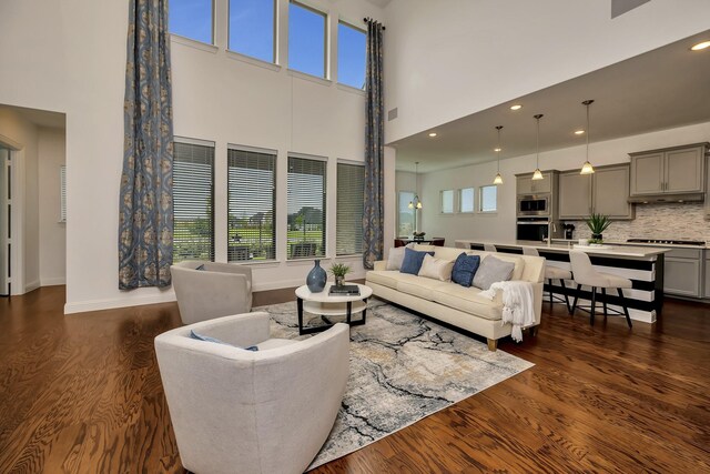 2203 Miranda Ln, Rockwall, TX 75087 - living area featuring dark wood-type flooring, a high ceiling, baseboards, and recessed lighting