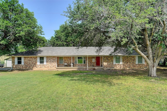 ranch-style home featuring brick siding and a front yard