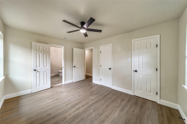 3701 Lamesa Dr, Garland, TX 75041 - unfurnished bedroom with wood finished floors, baseboards, ensuite bath, and ceiling fan