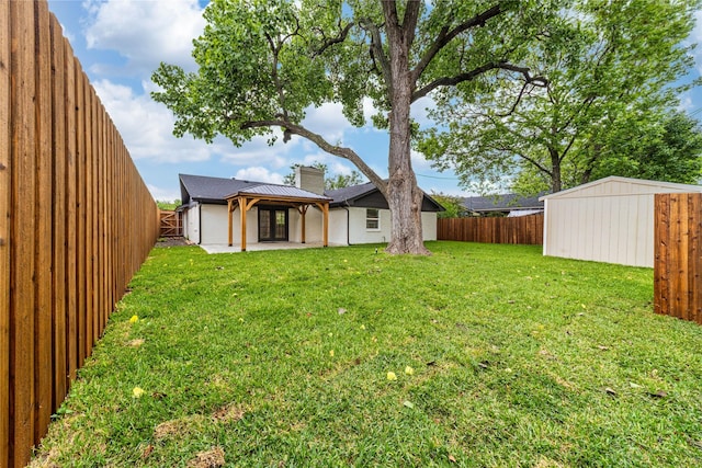 3701 Lamesa Dr, Garland, TX 75041 - view of yard featuring a patio area, an outdoor structure, and a storage unit