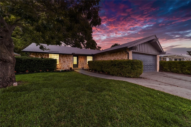 3701 Lamesa Dr, Garland, TX 75041 - ranch-style home with stone siding, a garage, concrete driveway, and a yard