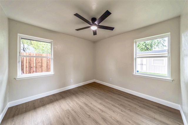 3701 Lamesa Dr, Garland, TX 75041 - unfurnished room with baseboards, wood finished floors, plenty of natural light, and ceiling fan