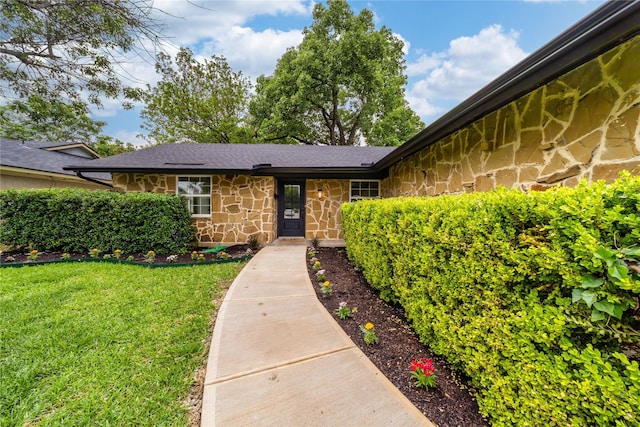 3701 Lamesa Dr, Garland, TX 75041 - doorway to property featuring stone siding and a lawn