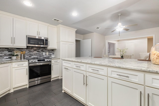 kitchen featuring ceiling fan, visible vents, appliances with stainless steel finishes, tasteful backsplash, and white cabinets