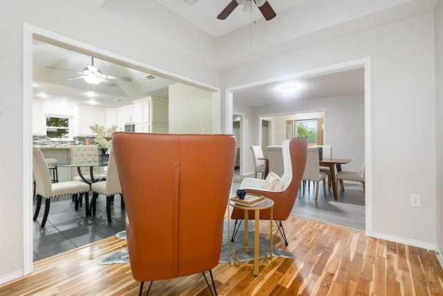 dining area with a ceiling fan, baseboards, plenty of natural light, and light wood-style floors
