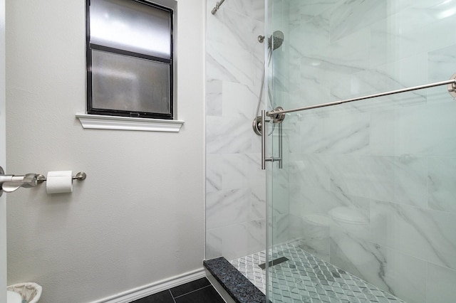 full bath featuring baseboards, tile patterned floors, and a stall shower