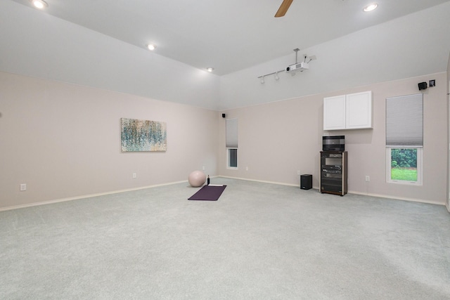 unfurnished living room featuring light colored carpet, a ceiling fan, baseboards, and recessed lighting