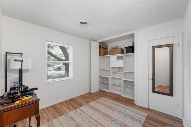bedroom with visible vents and wood finished floors