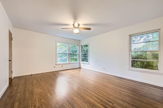 unfurnished room with visible vents, ceiling fan, wood finished floors, and a healthy amount of sunlight