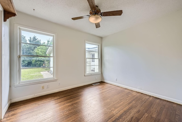 unfurnished room featuring baseboards, a textured ceiling, ceiling fan, and wood finished floors