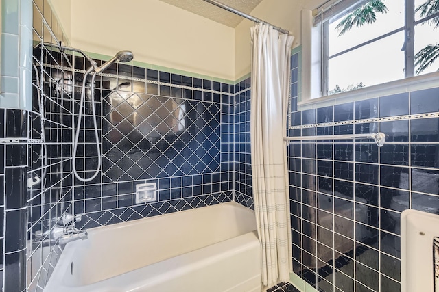 full bath featuring shower / tub combo with curtain