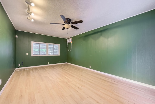 spare room featuring baseboards, a ceiling fan, and wood finished floors