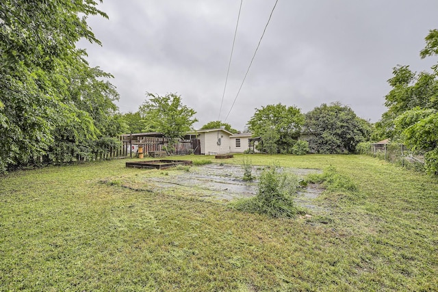 view of yard with a fenced backyard and a wooden deck