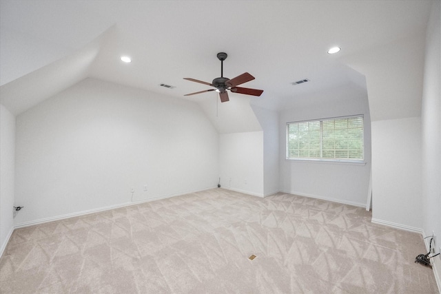 bonus room with light carpet, vaulted ceiling, and visible vents