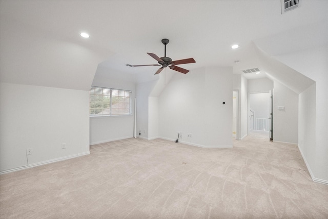 additional living space with visible vents, a ceiling fan, lofted ceiling, and light carpet