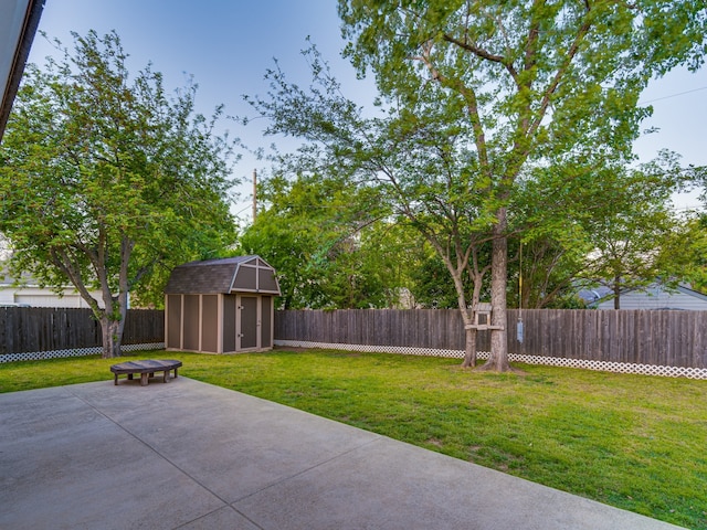 5005 Drew Ct, Arlington, TX 76017 - view of yard with a storage unit, a fenced backyard, a patio area, and an outbuilding