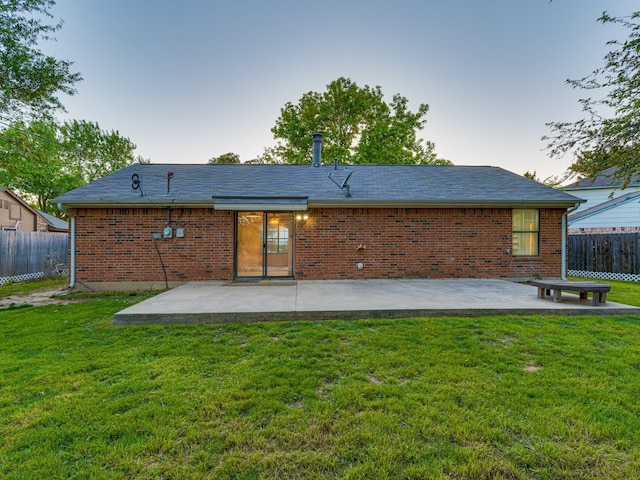 5005 Drew Ct, Arlington, TX 76017 - back of house at dusk featuring a patio, fence, and brick siding