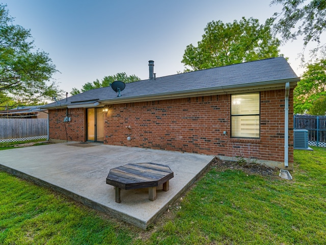 5005 Drew Ct, Arlington, TX 76017 - back of property with a lawn, a patio area, brick siding, fence, and cooling unit