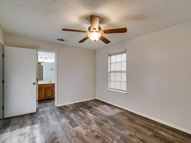 5005 Drew Ct, Arlington, TX 76017 - unfurnished bedroom with ceiling fan, a textured ceiling, baseboards, visible vents, and dark wood-style floors