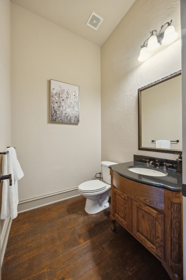1041 Bandelier Dr, Allen, TX 75013 - half bathroom featuring vanity, toilet, wood finished floors, and vaulted ceiling