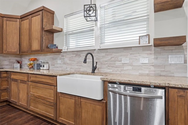 kitchen with stainless steel dishwasher, open shelves, a sink, and brown cabinets