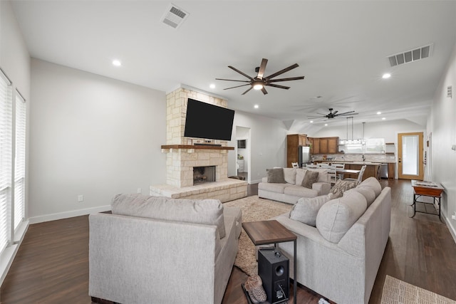 living room featuring dark wood-style flooring, a ceiling fan, and visible vents