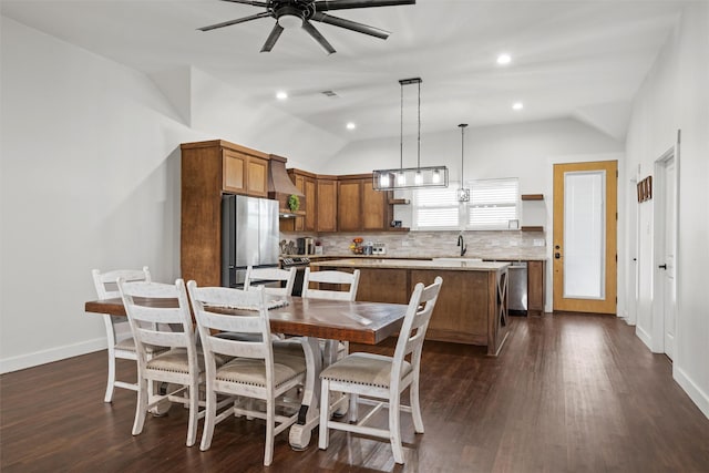 dining area with baseboards, ceiling fan, dark wood-type flooring, and lofted ceiling