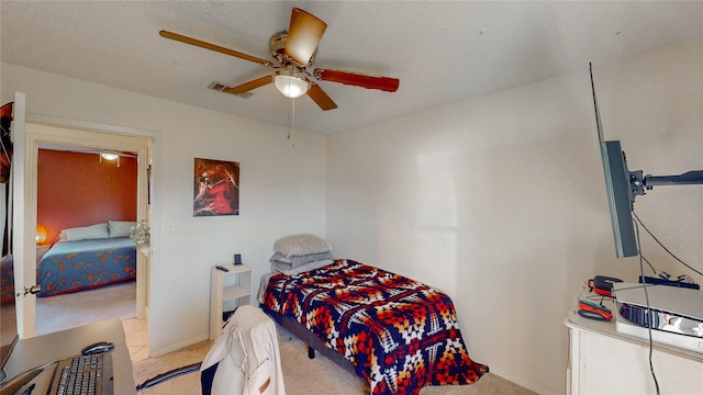 bedroom with light carpet, a ceiling fan, and visible vents