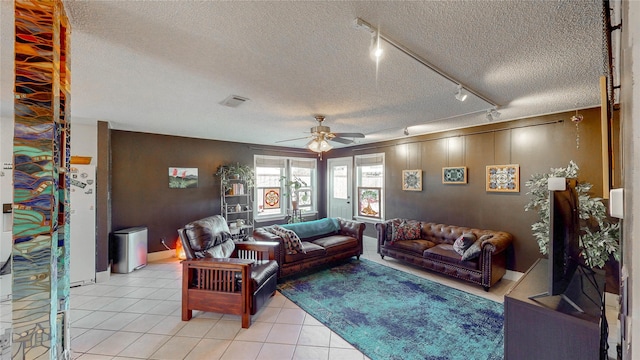 living area featuring a ceiling fan, a textured ceiling, visible vents, light tile patterned floors, and track lighting