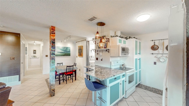 kitchen featuring blue cabinets, visible vents, glass insert cabinets, white appliances, and light tile patterned flooring