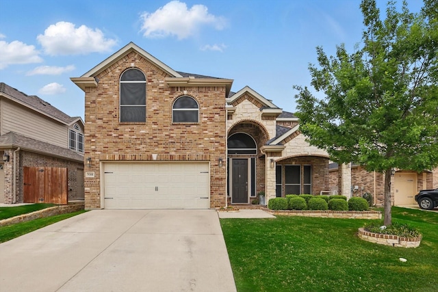 traditional-style house with fence, an attached garage, brick siding, a front yard, and driveway