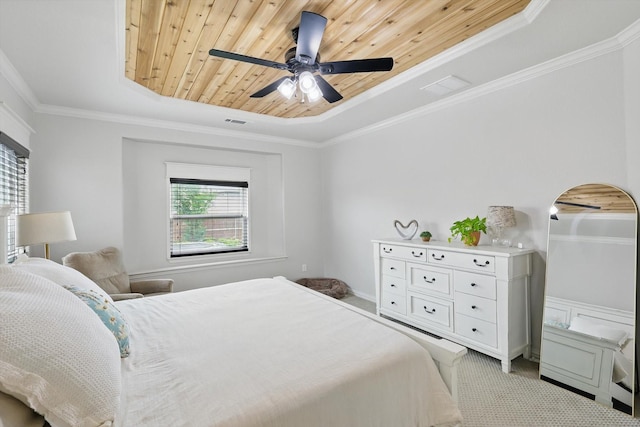 carpeted bedroom with ornamental molding, wood ceiling, arched walkways, a tray ceiling, and a ceiling fan