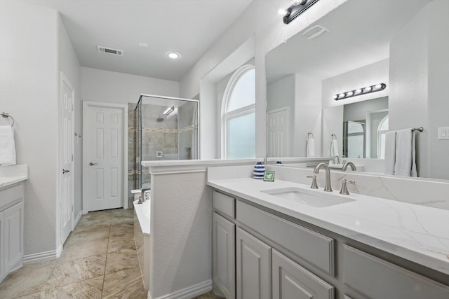 bathroom with vanity, baseboards, visible vents, and a stall shower