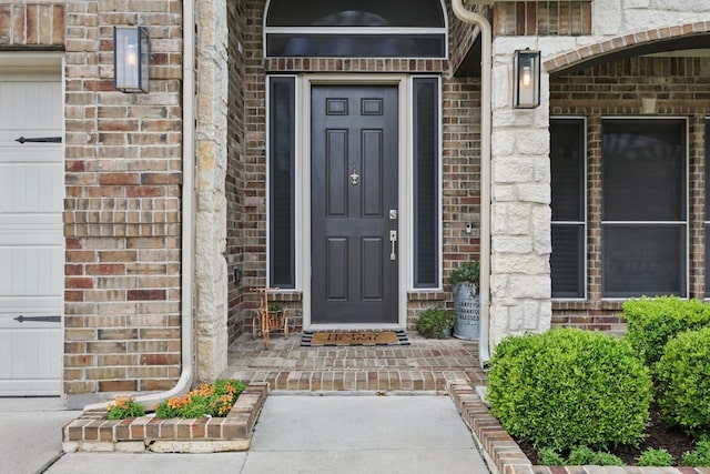 doorway to property with brick siding